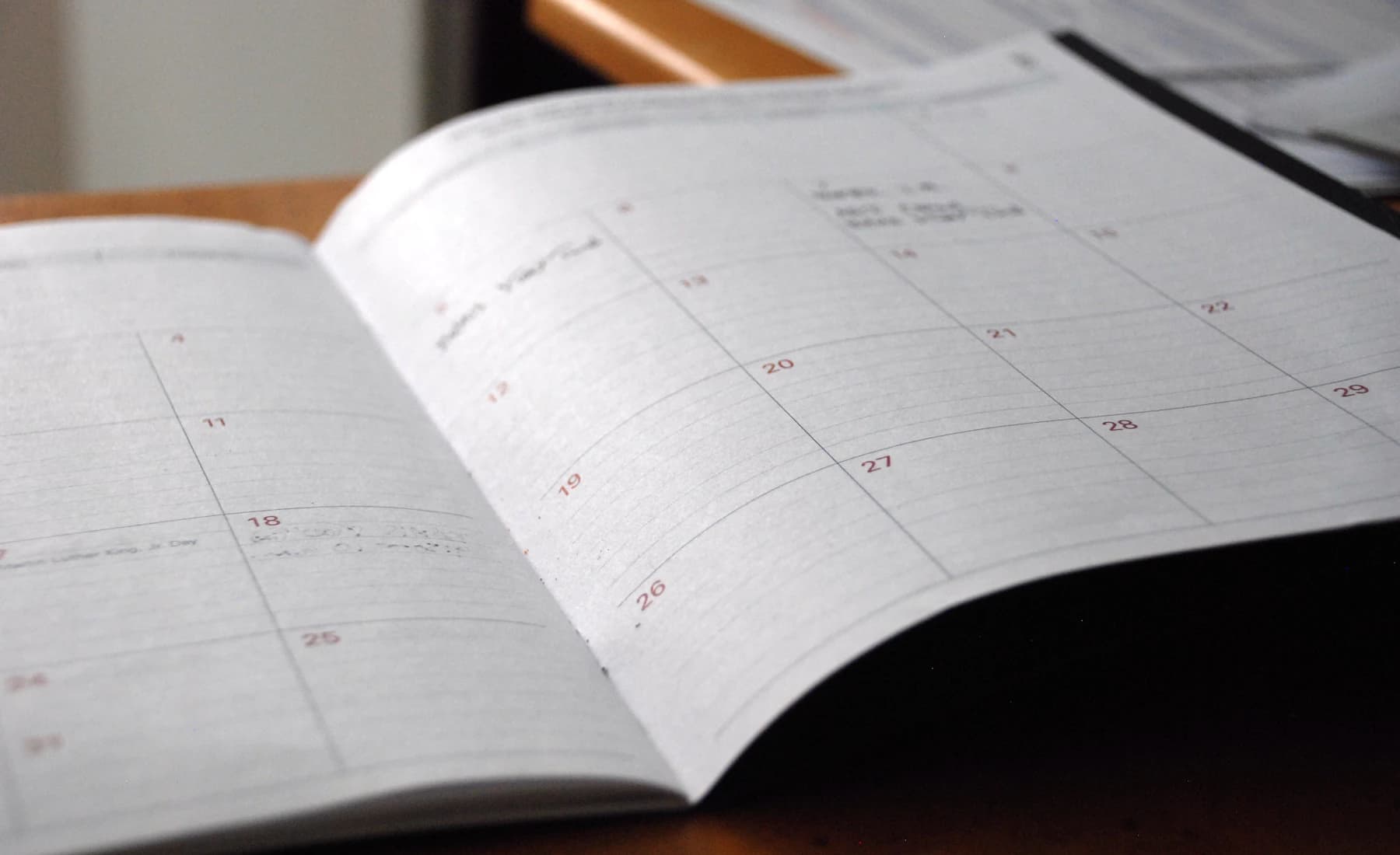 An open monthly paper planner on a desk